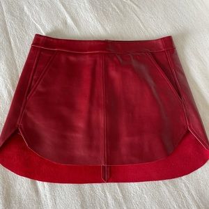 Michelle Mason red leather mini skirt.